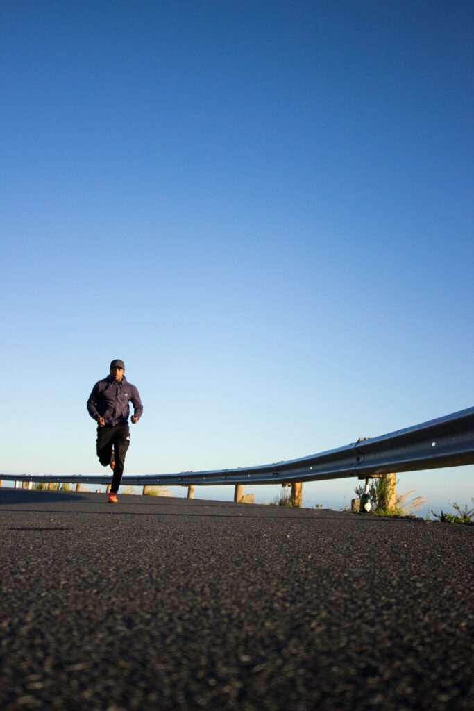 A person walking on a scenic trail, symbolizing movement, clarity, and physical wellness in recovery
