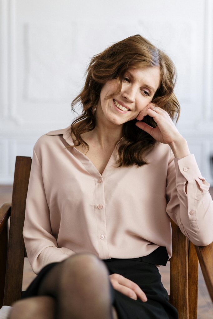 A thoughtful woman reflecting while seated on a couch during a life transition counseling session