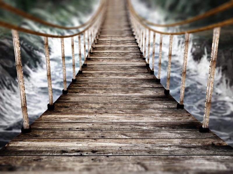 Old wooden suspended bridge on wild river. 3D illustration.